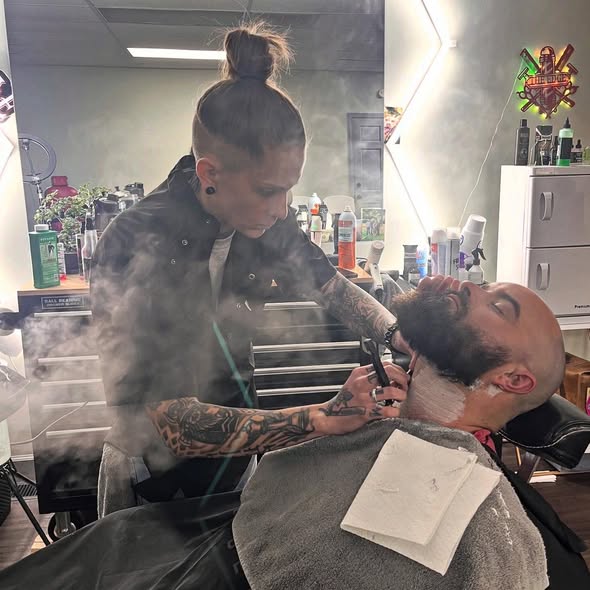 Nae performing a classic straight razor shave with steam at The Edge Barbershop Linton IN